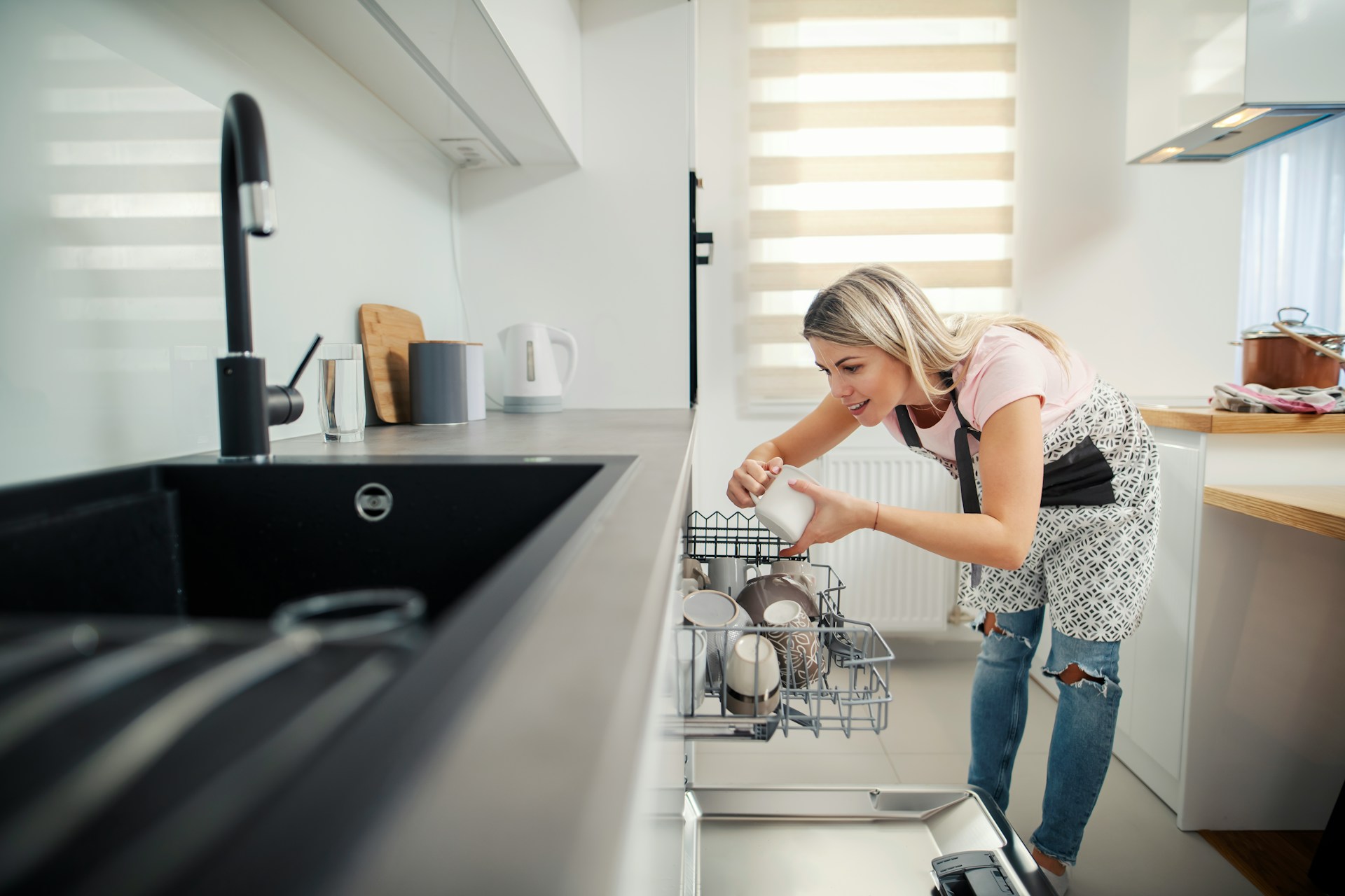 woman loading dishwasher